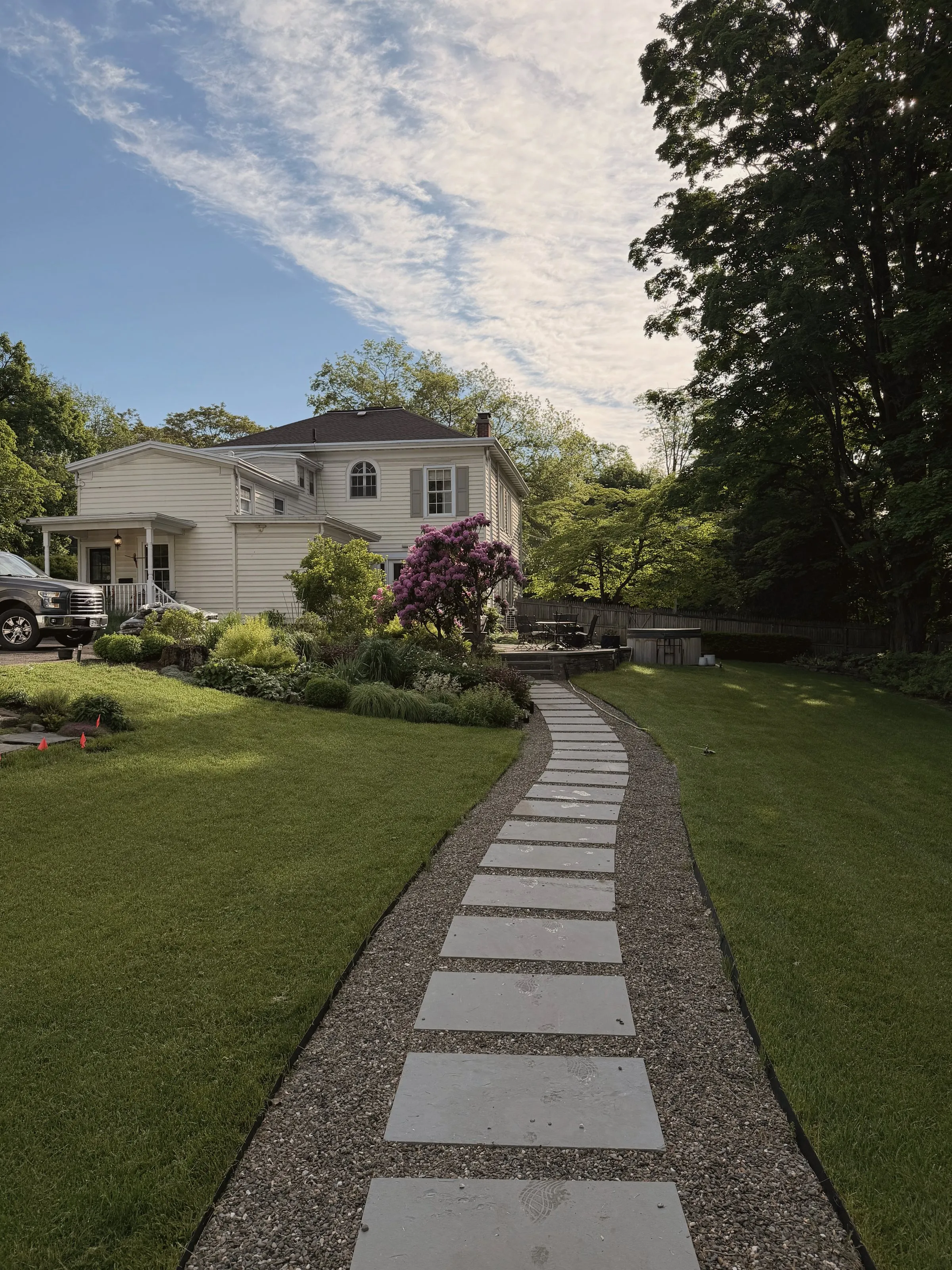 Stepping-stone path through the gardens toward the pool